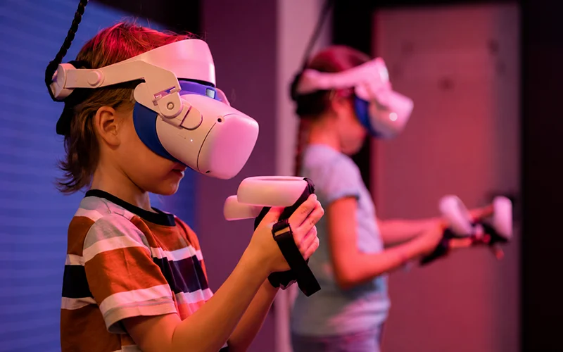 Children enjoying a VR experience in an indoor family entertainment center.