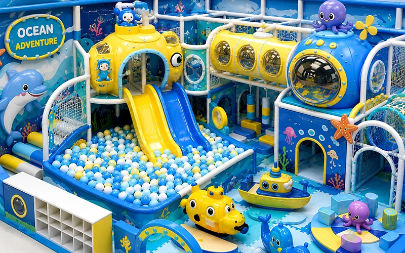3D rendering of an ocean and submarine themed indoor playground featuring slides, ball pit, tunnel play structures, and interactive marine-themed play elements for children.