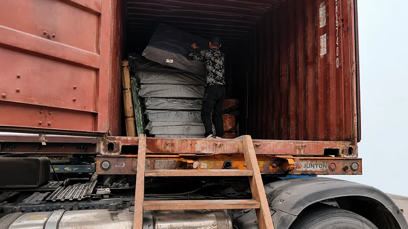Workers loading playground equipment into a shipping container at the Lebanplay factory, Slovakia Velky Meder
