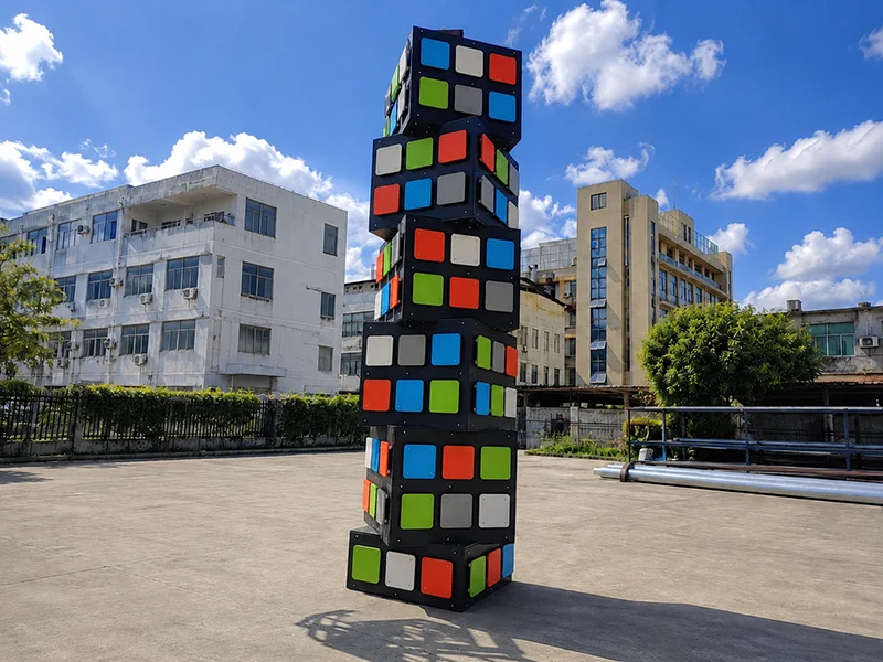 Cube climbing tower for indoor playground with stacked 3D climbing modules and multi-angle climbing surfaces for kids adventure play