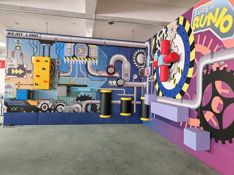 Interactive challenge wall for indoor playground with climbing grips, obstacle elements, soft play barriers, and reaction-based activities for kids