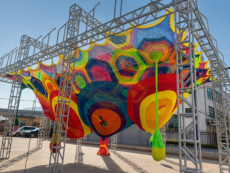 Rainbow rope net climbing playground canopy structure with multicolor woven design for indoor and outdoor adventure play equipment by Lebanplay