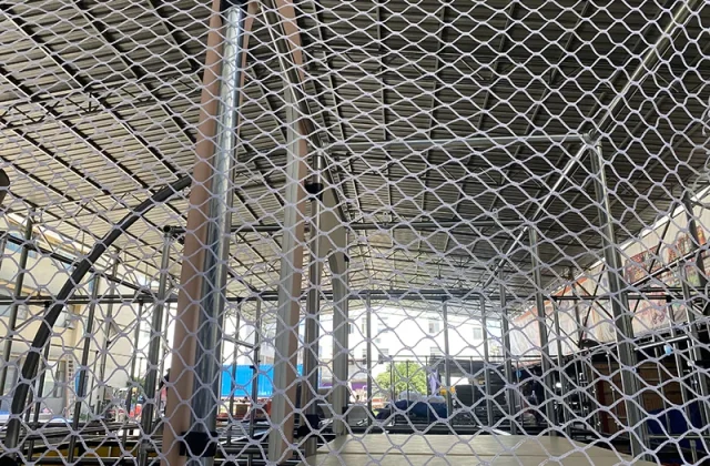 Safety net installation for an indoor playground structure with steel frame